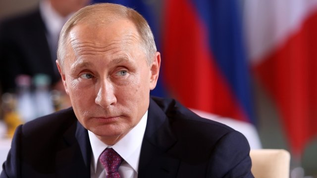 Vladimir Putin attends a meeting to discuss the Ukrainian peace process