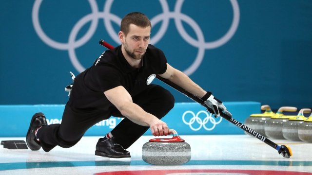 Aleksandr Krushelnitckii throws a curling stone
