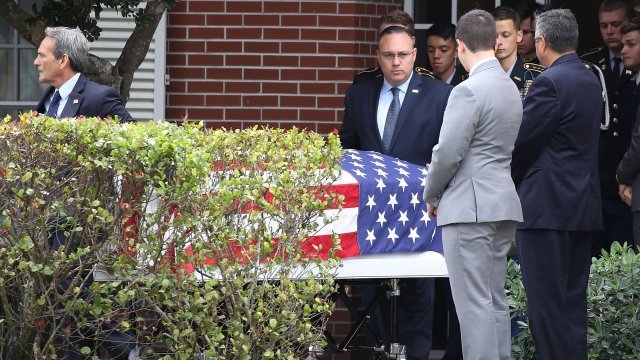 Flag draped over casket of Alaina Petty, one of three Medal of Heroism recipients