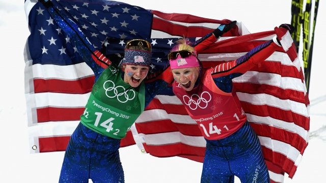 Jessica Diggins of the United States and Kikkan Randall of the United States celebrate.