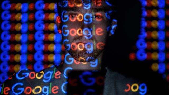 Google logos projected on a man