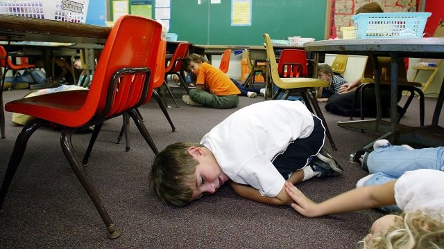 Kindergarten students lie on the floor during a classroom lockdown drill February 18, 2003 in Oahu, Hawaii.