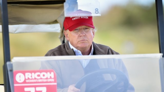 President Trump rides in a golf cart
