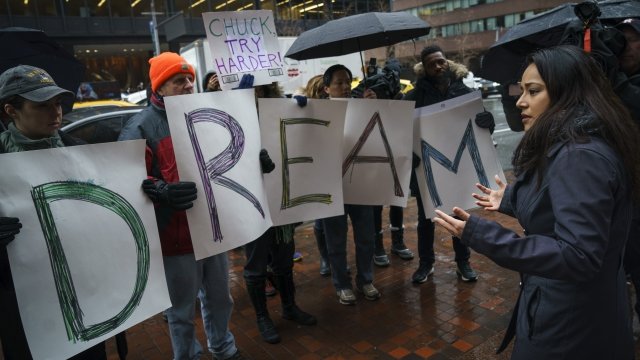 People hold "Dream" signs