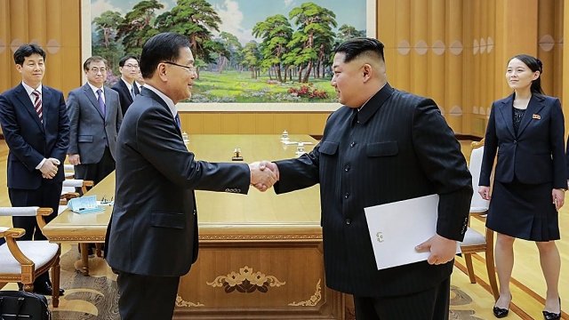 A South Korean envoy, left, meeting with Kim Jong-un