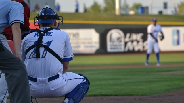 A minor league catcher crouching behind the plate