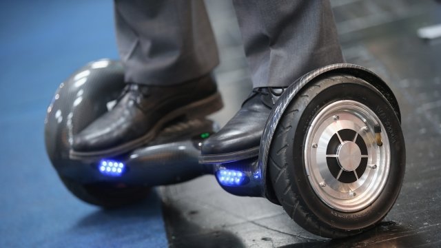 A man rides a hoverboard at the 2016 CeBIT digital technology trade fair
