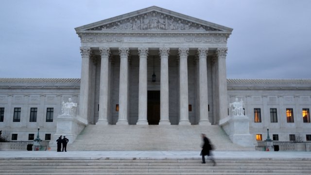 A man walks up the steps of the U.S. Supreme Court.