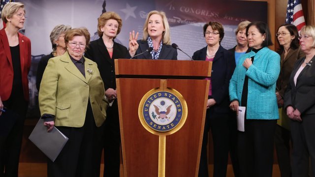 Kirsten Gillibrand speaks surrounded by female senators