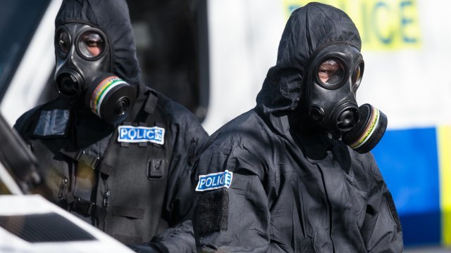 Investigators wear protective suits while looking into the March 4 nerve agent attack