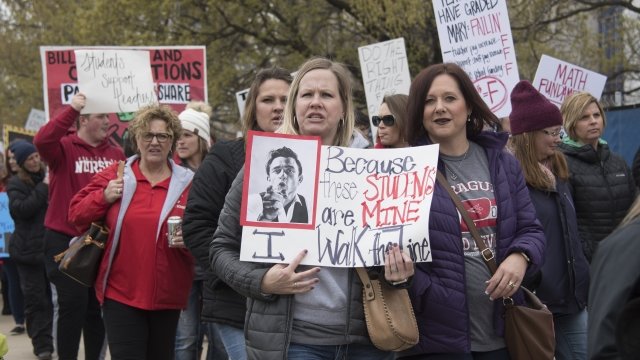 Teachers walk the picket line during a rally at the state capitol on April 2, 2018 in Oklahoma City, Oklahoma.