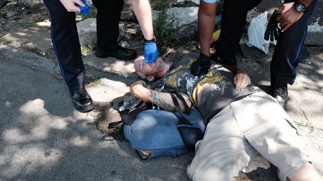 Police administer naloxone as they try to revive a man who overdosed on heroin in Philadelphia
