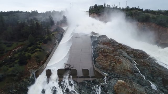 Water flows on the partially-collapse Oroville Dam spillway