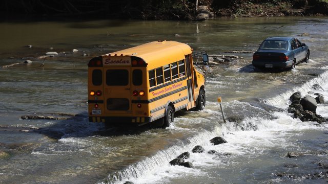 School bus crosses bridge during flooding