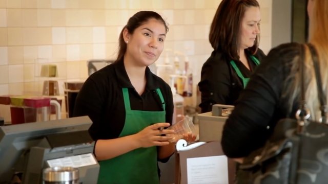 Female barista serving a customer at Starbucks