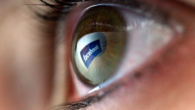 Facebook logo reflected in an eye