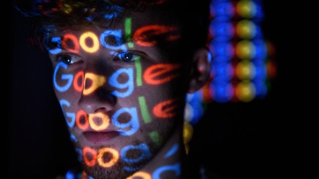 Man with "Google" projected on his face