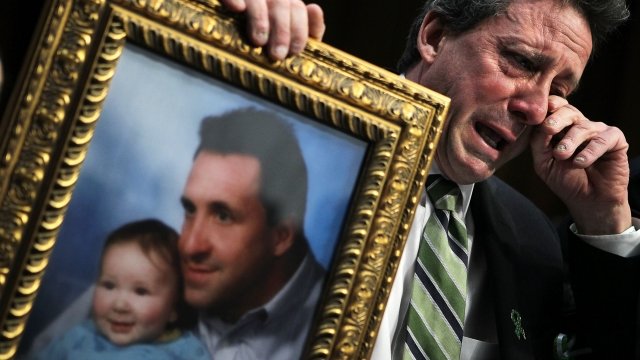 Father of a Sandy Hook victim holds a framed photo of his son