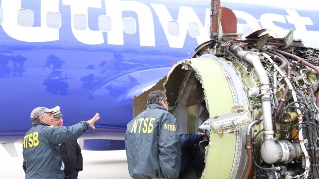 Investigators examine the blown engine on Southwest Airlines flight 1380