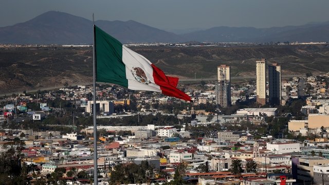A Mexican flag flies over the city of Tijuana