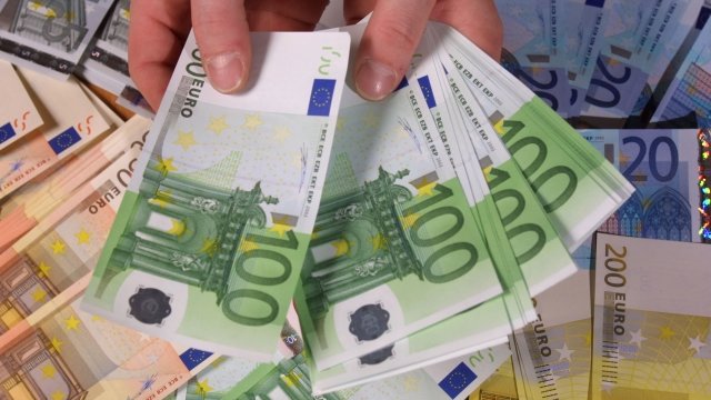 Hands holding Euros