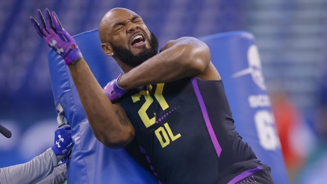 A player grimaces while running a drill at the NFL Scouting Combine.