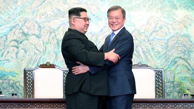 North Korean leader Kim Jong-un and South Korean President Moon Jae-in embrace.