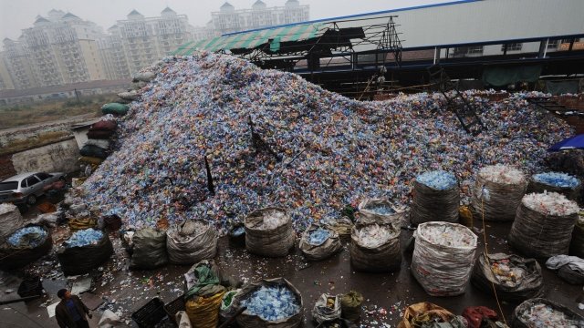 Used plastic bottles sit in a pile at a recycling facility in China