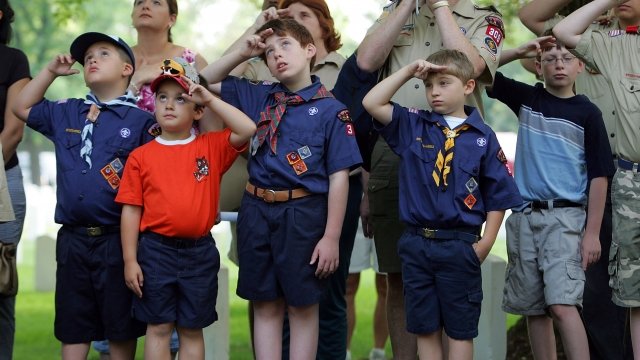 A group of scouts salute the flag