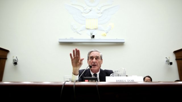 Special counsel Robert Mueller sits at a podium