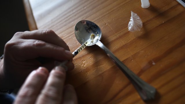 Drug user fills syringe