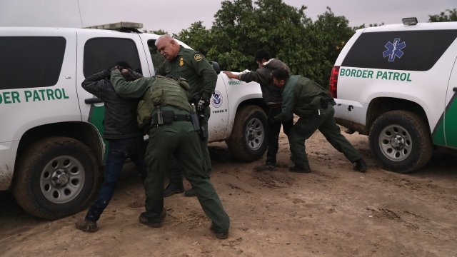 Border Patrol agents arrest immigrants.