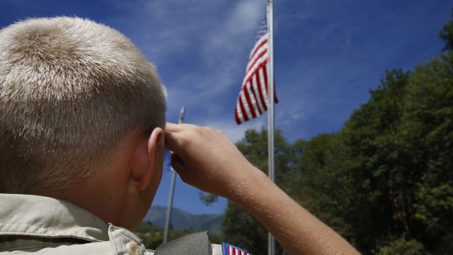 Boy Scout salutes the American flag