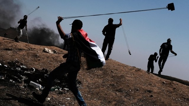 Protesters in Gaza wield slings to throw rocks towards Israeli border