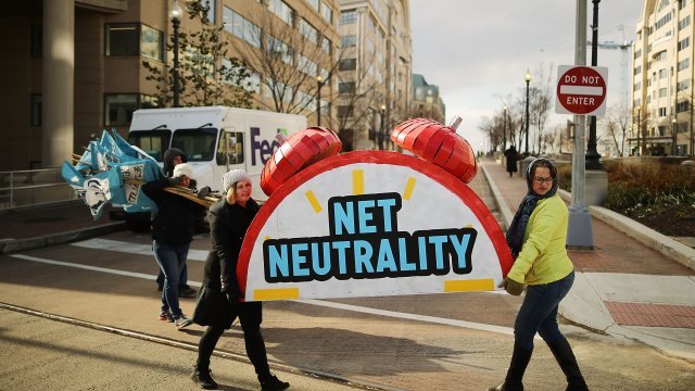 Women carry prop in net neutrality repeal protest
