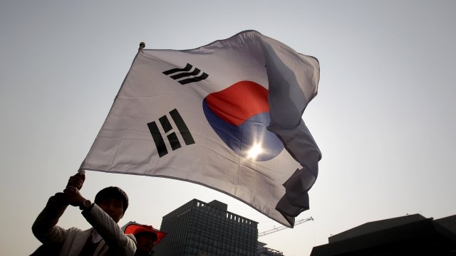 A person waving a South Korean flag