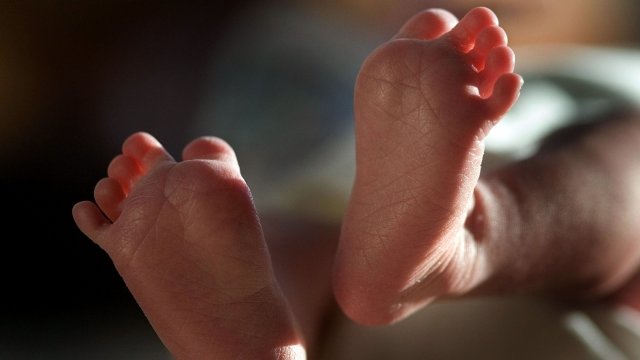 A two-week-old boy finds his feet in his new world.