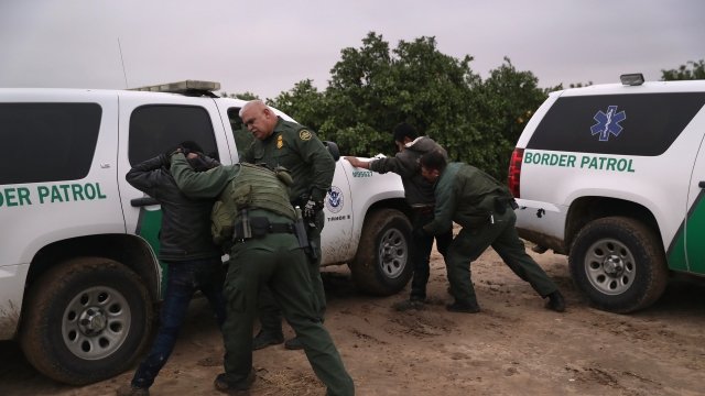 U.S. Border Patrol agents body search undocumented immigrants from Central America