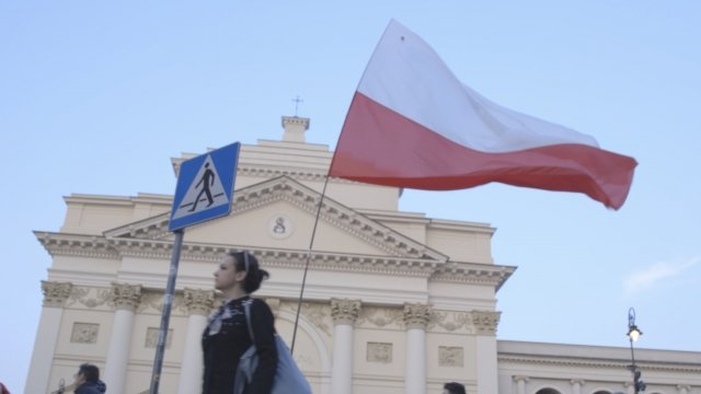 A flag flies outside a protest in Warsaw, Poland