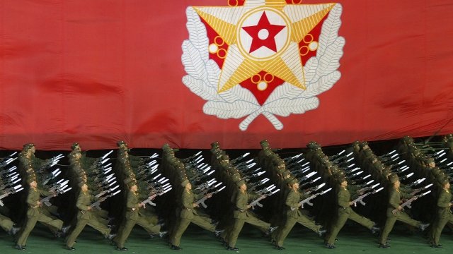 North Korean military cadets hold North Korean leader Kim Jong-Il's flag.