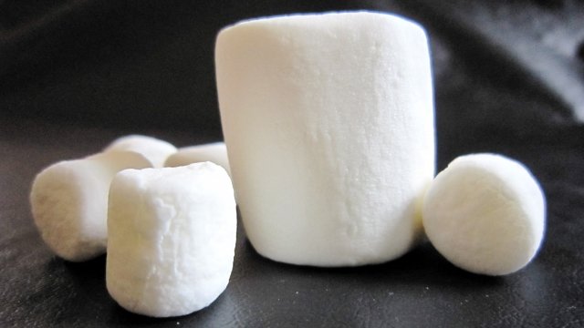 A pile of marshmallows on a black surface