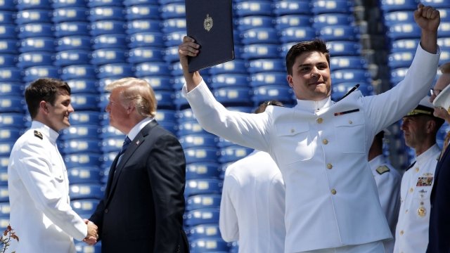 President Donald Trump shakes hands with a graduate of the United States Naval Academy