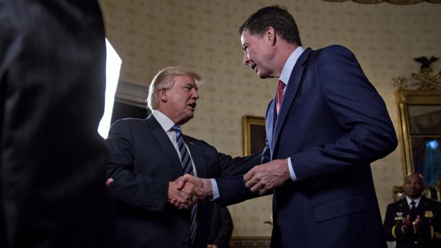 Donald Trump shakes hands with James Comey.