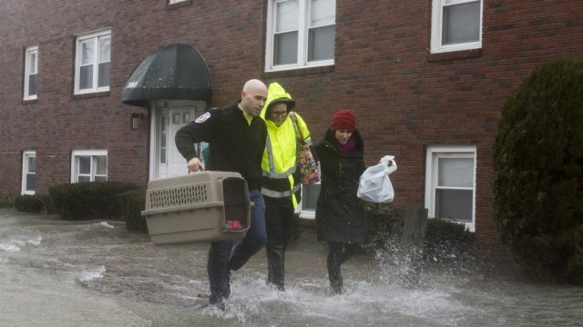 People run in a flooded street