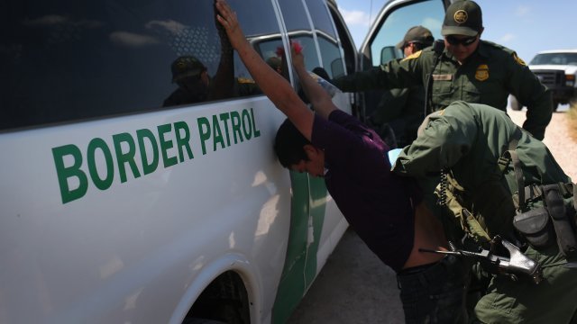 U.S. Border Patrol agents detain undocumented immigrants after they crossed the border from Mexico into the United States