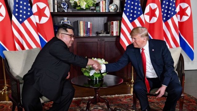 Kim Jong-un and Donald Trump shake hands