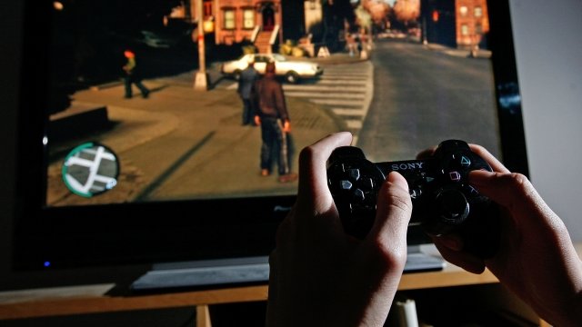 A person is shown playing a video game
