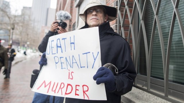 Joe Kebartas of South Boston protests the death penalty outside the John Joseph Moakley United States Courthouse.