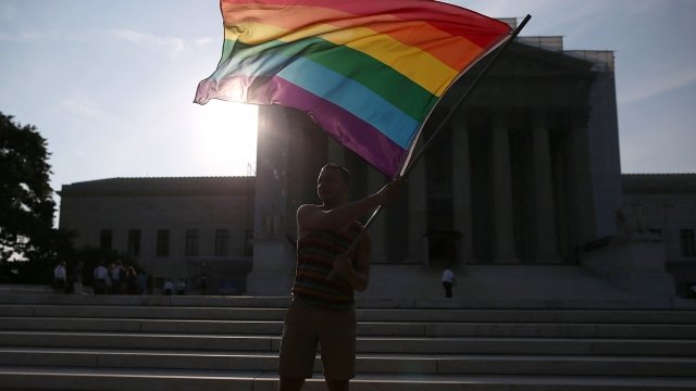 Gay rights activist Vin Testa of DC, waves a flag in front of the U.S. Supreme Court building, June 26, 2013 in Washington DC