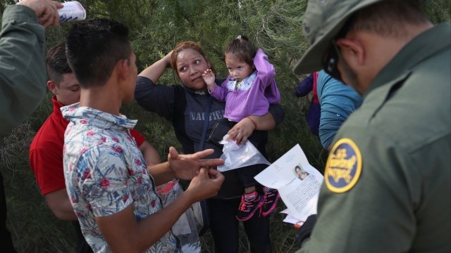 U.S. Border Patrol agents talk to a group of asylum seekers from Central America